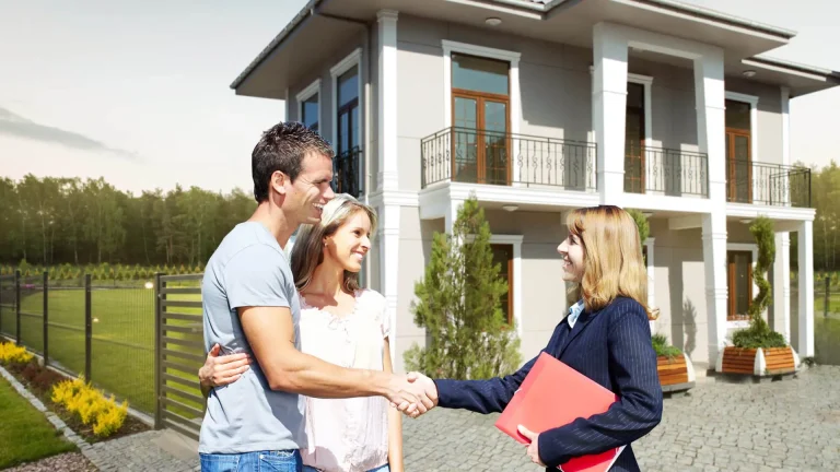 Recovery housing consultation showing a couple meeting with a professional outside a modern residential property.